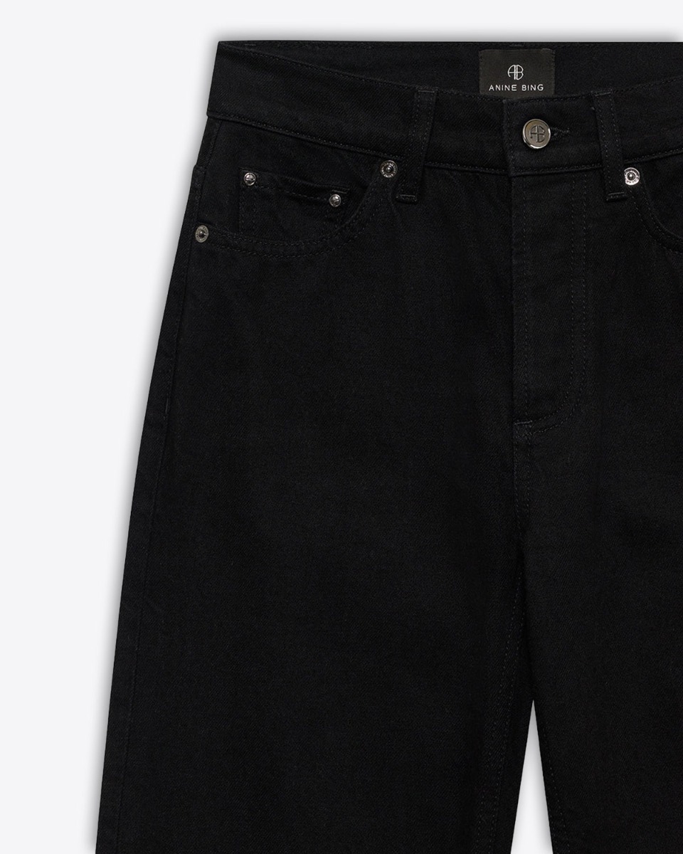 Jeans taille haute Bruno Anine Bing en toile noire. Détail des rivets.