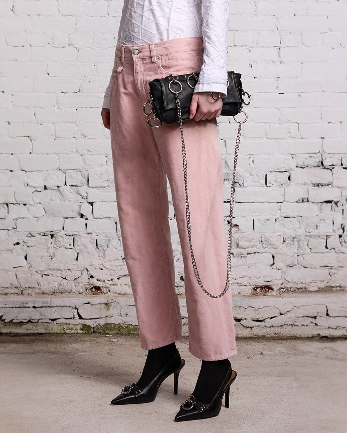 Jean Boyfriend en velours lisse rose r13. Porté avec une pochette noire. 