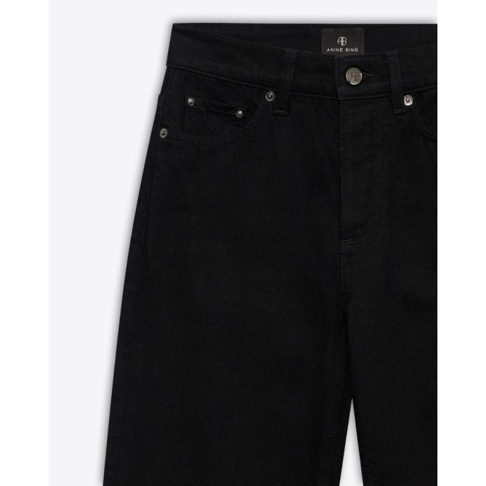 Jeans taille haute Bruno Anine Bing en toile noire. Détail des rivets.