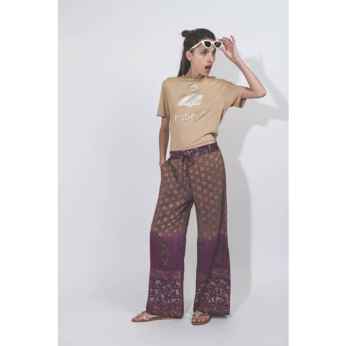 Pantalon fluide en soie imprimée Paul Hand.So.On. Pièce unique réalisée dans un sari vintage. Porté avec un tee-shirt en lin beige.