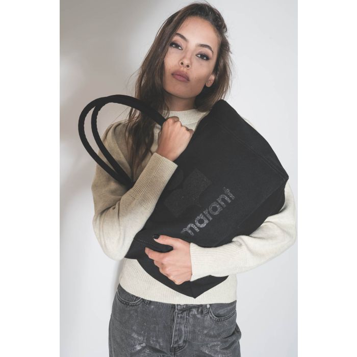 Cabas en toile noir Logo "MARANT" à paillettes noires ton sur ton Yenky Zip Isabel Marant. Porté dans les bras.
