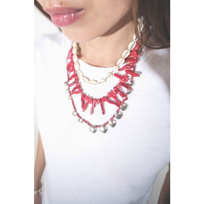 Collier de perles et os rouges Jolana Isabel Marant. Porté en accumulation avec un collier coquillage Noki et un collier Adriel en perles rouges et pampilles en métal argenté Isabel Marant. 