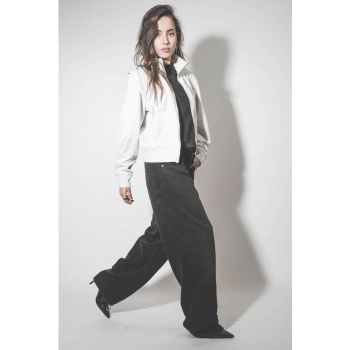 Jean large noir délavé Joanny Marant Etoile. Porté avec des boots à talons en cuir noir.