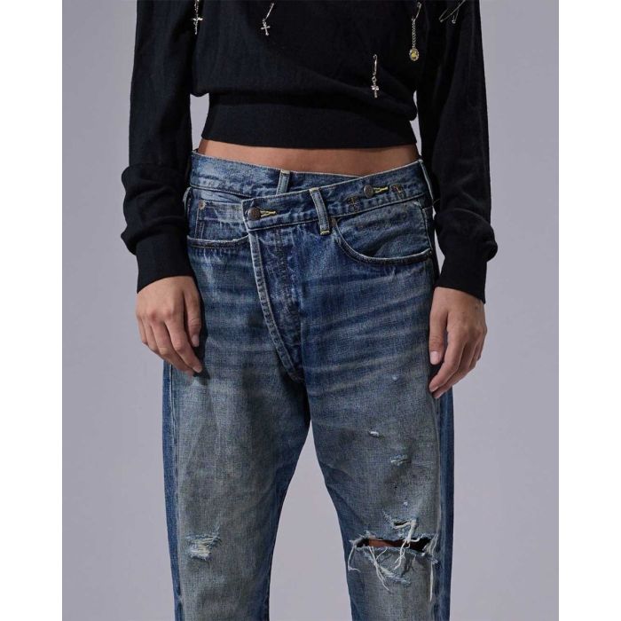 Jean crossover R13 en denim bleu déchiré Léo Blue. Détails du délavage et de la fermeture croisée.