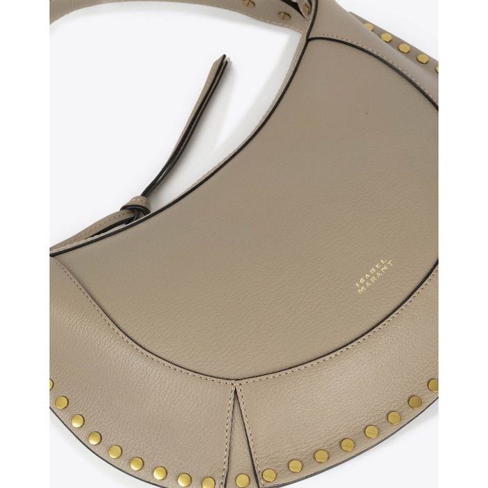 Sac Naoko Isabel Marant en cuir grainé taupe. Anse courte et bandoulière longue amovible et réglable. Porté épaule et main ou épaule et croisé. Face. Détail du logo embossé "Isabel Marant" devant.