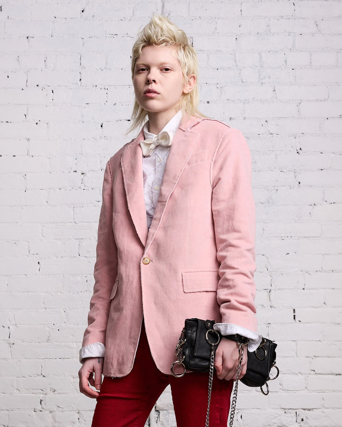 Blazer en velours rose R13 porté avec une chemise blanche.